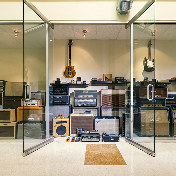 Line 6 office display of our amp museum with many vintage amps and effects displayed